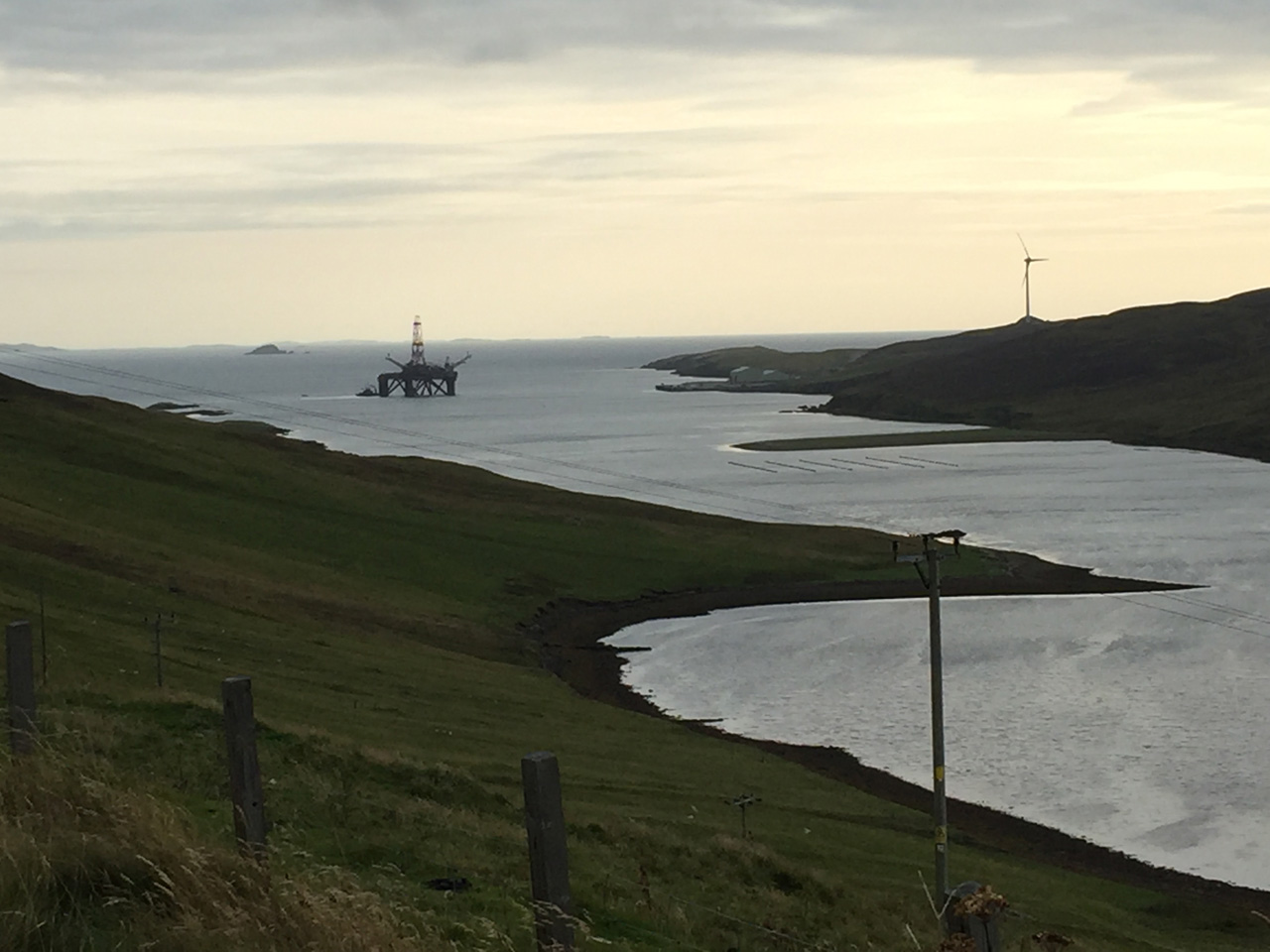 Old energy meets new energy. View from A970 near Shetland Golf Club.