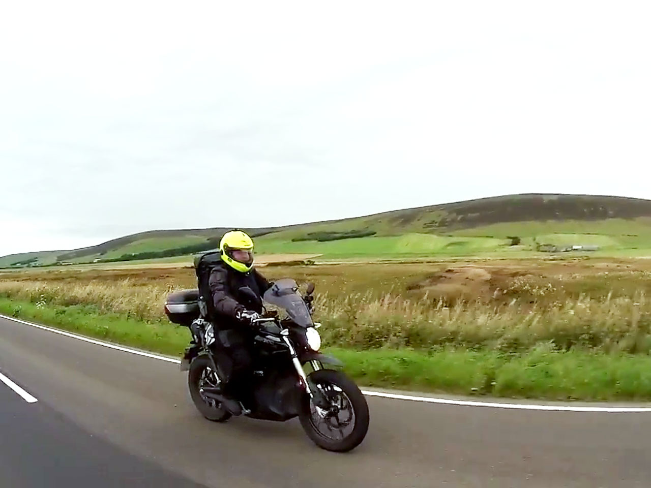 John Chivers with his Zero DSR electric motorcycle riding on Orkney.